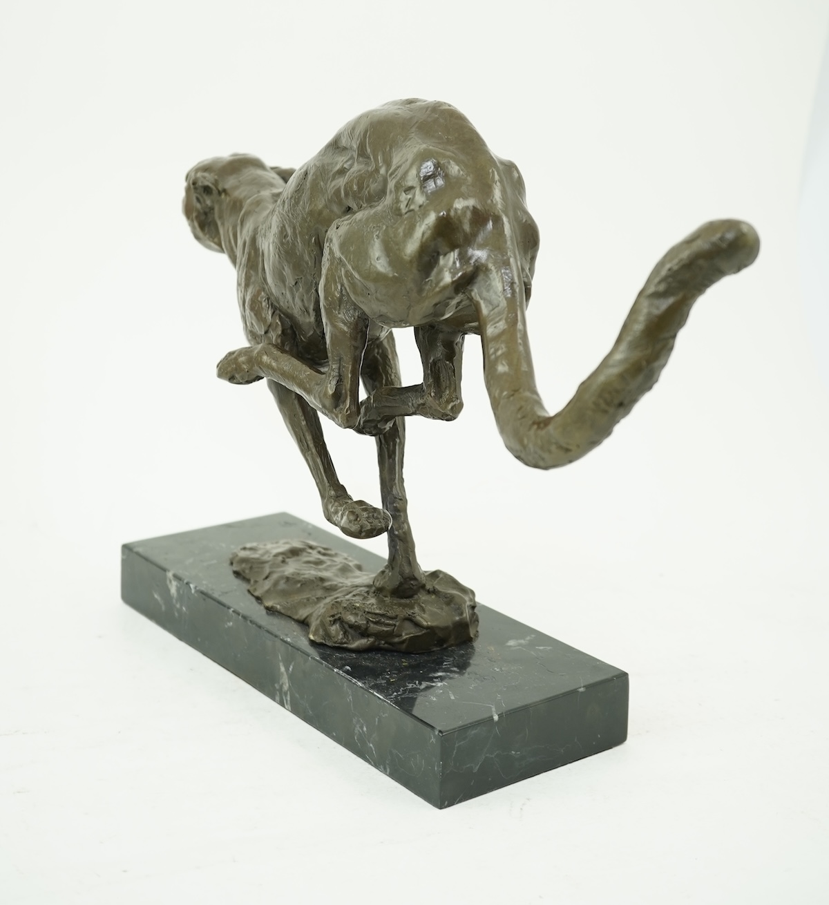 Manner of Mark Coreth (b. 1958): A patinated bronze model of a cheetah in full flight
